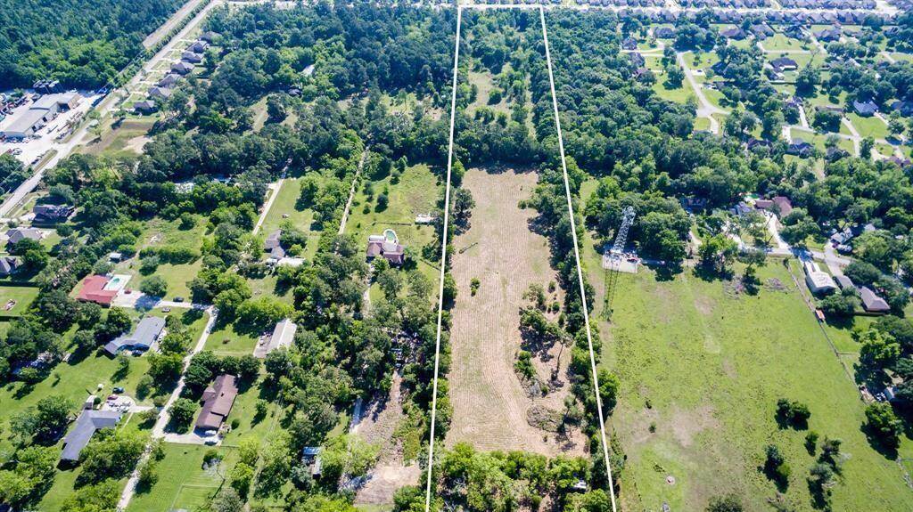 This aerial photo showcases a large, Ready for developed parcel of land bordered by residential neighborhoods, offering a blank canvas for potential development or a private estate within an established community.
