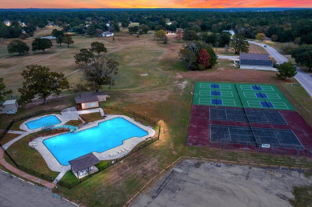 Aerial views of the tennis and pickle ball courts and pool available to all.