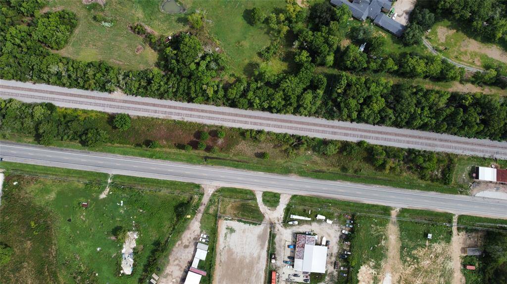 Notice the metal building on adjacent property to the right.  This land is capable of that and more in a very developing area of Humble/Huffman.