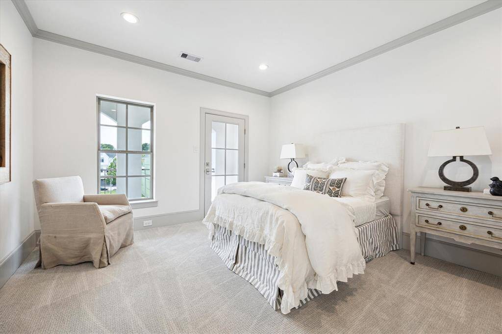 Third-floor Secondary Bedroom with walk-in closet, and glass door for access to balcony.