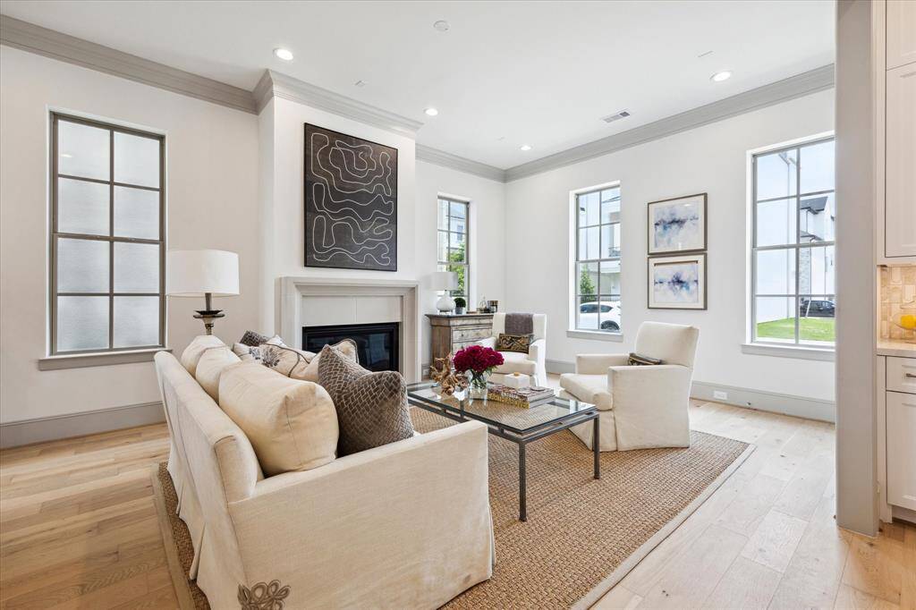 Living Room features cast stone fireplace and wonderful natural light from ample windows.