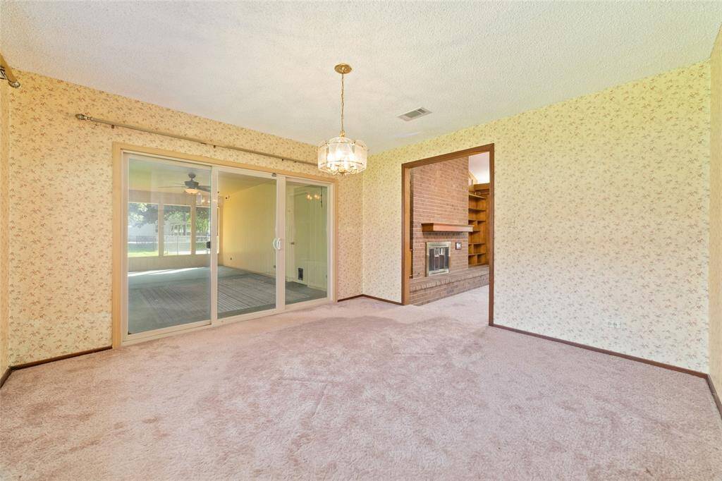 Just off the dining room is a sliding glass door that leads to the massive back porch.