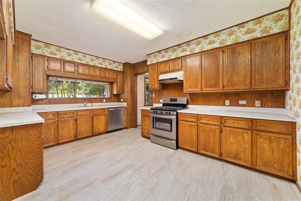 Open and spacious kitchen features stainless steel appliances.