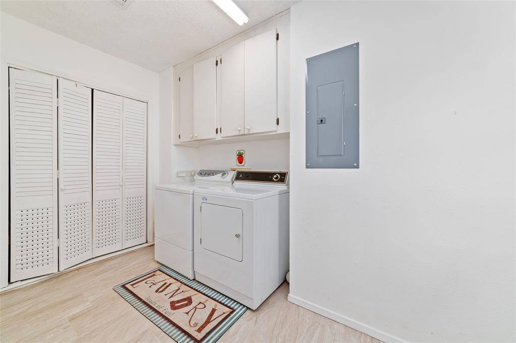 Just off the kitchen is the oversized laundry room with cabinets.