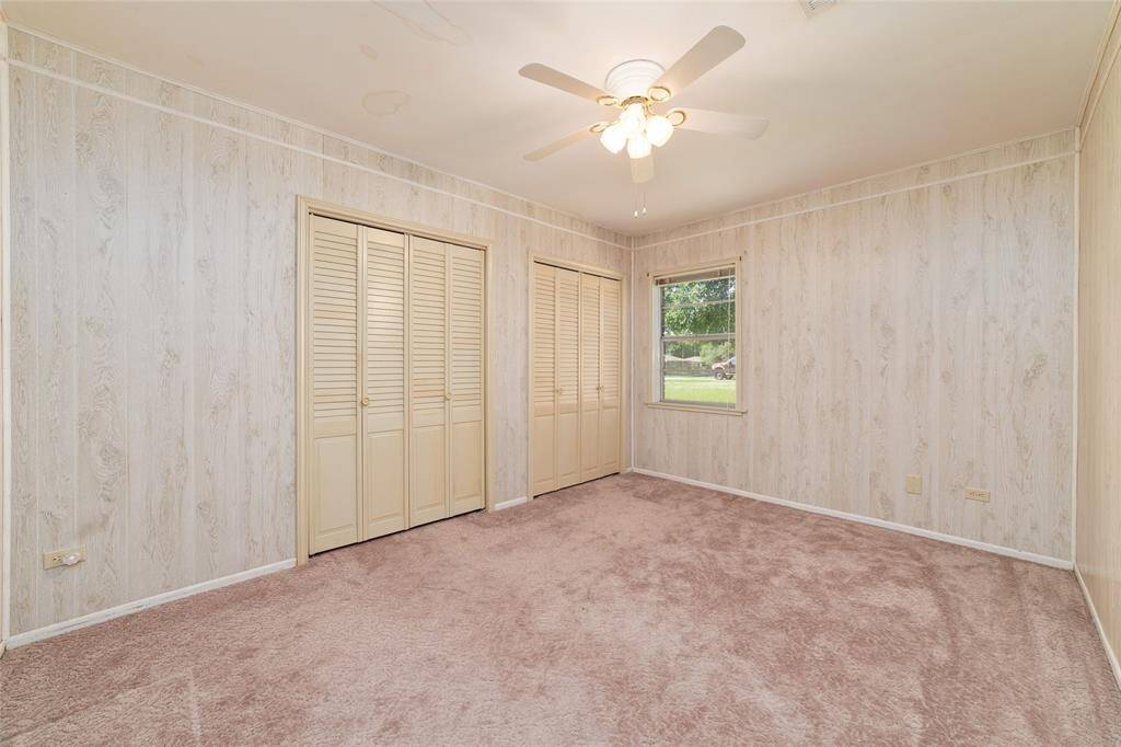 This bedroom with large closet space and window overlooking back yard.