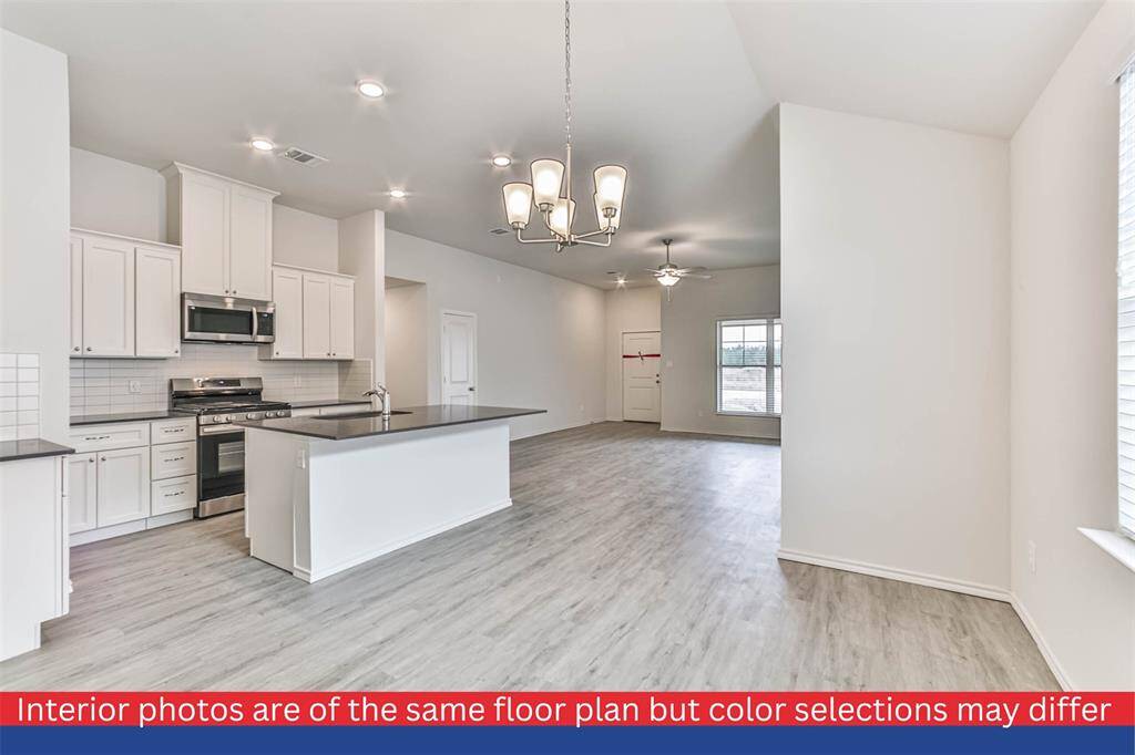 The kitchen is a chef's delight, featuring sleek countertops, ample cabinet space, and state-of-the-art appliances. Prepare delicious meals with ease while still being part of the conversation, thanks to the adjacent dining area.