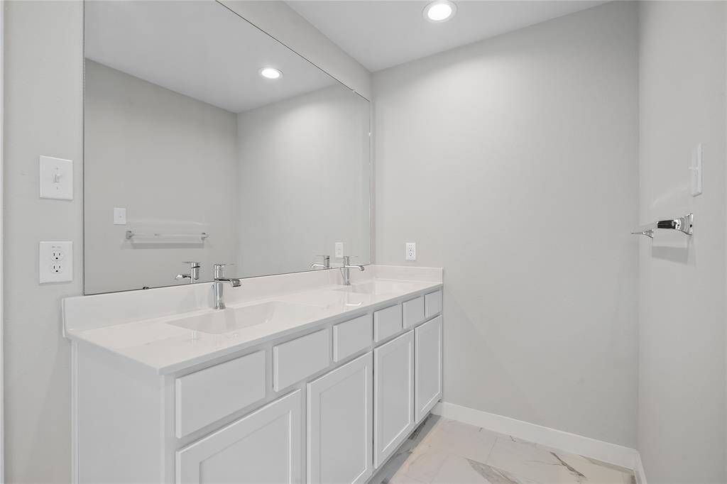 This primary bathroom is definitely move-in ready! Featuring white stained cabinets with light countertops, spacious walk-in closet with shelving, high ceilings, custom paint, sleek modern finishes.