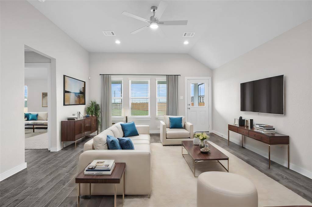 Gather the family and guests together in your lovely living room! Featuring high ceilings, recessed lighting, ceiling fan, custom paint, gorgeous floors and large windows that provide plenty of natural lighting throughout the day.