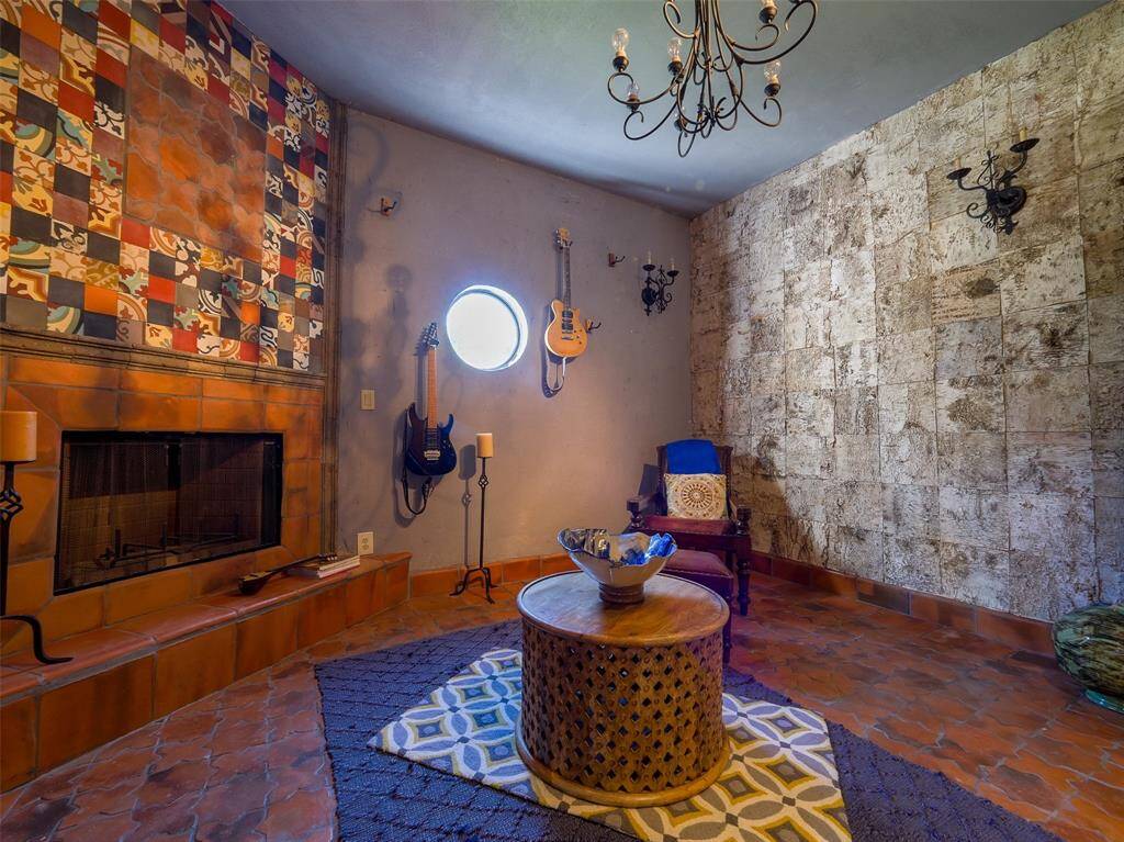 This den adjoins the upstairs primary bedroom and features a birch-bark wall facing the third wood burning fireplace.