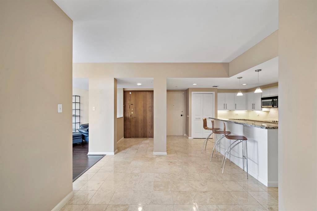 Step into the foyer where you'll be greeted by a bright open floor plan connecting the kitchen, living, and dining areas.