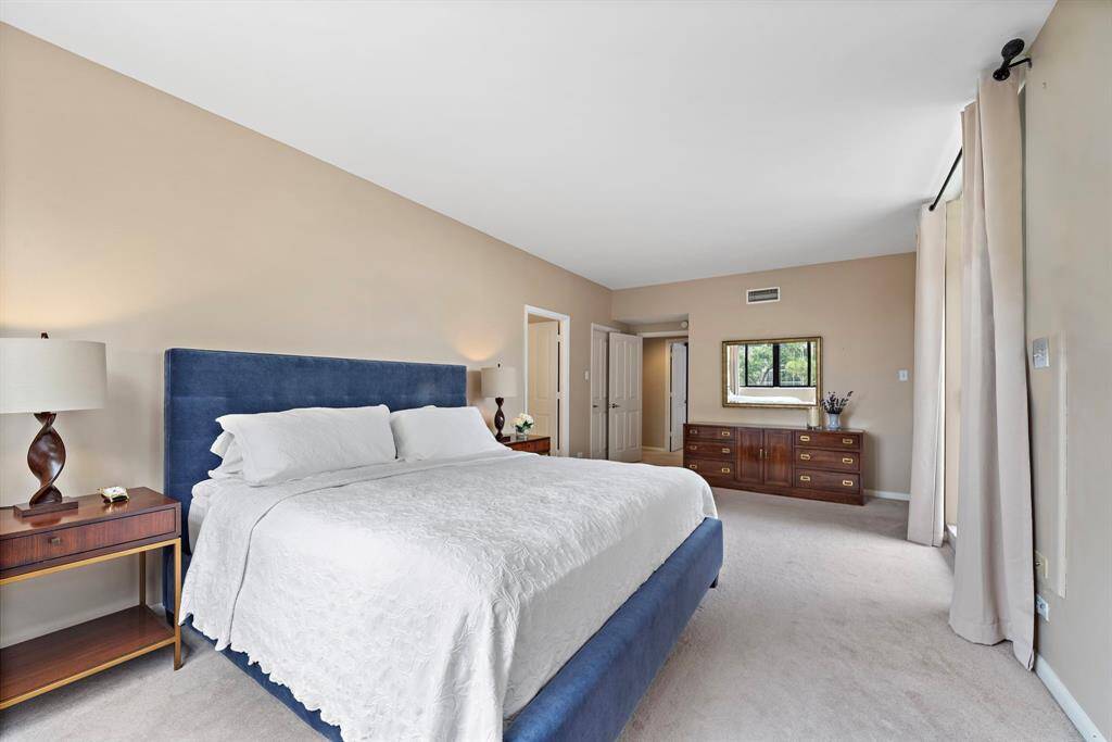 Another view of the 23' x 16' primary bedroom boasting two oversized walk-in closets and a lavish ensuite bathroom.