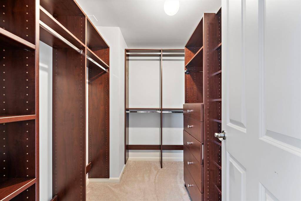 The large walk-in closet is fitted with built-in clothing racks, shelves, and drawers, offering optimal storage options for your personal belongings.