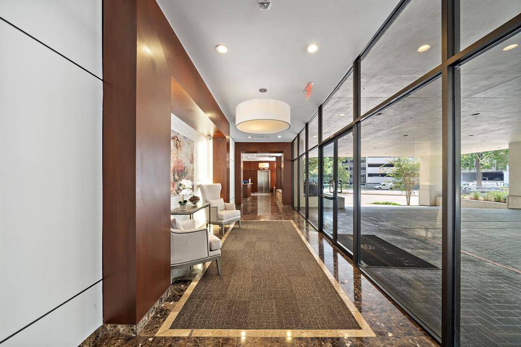 Residents at The Pinehollow are greeted by an inviting lobby with elegant interiors, lavish marble floors, and a seating area.
