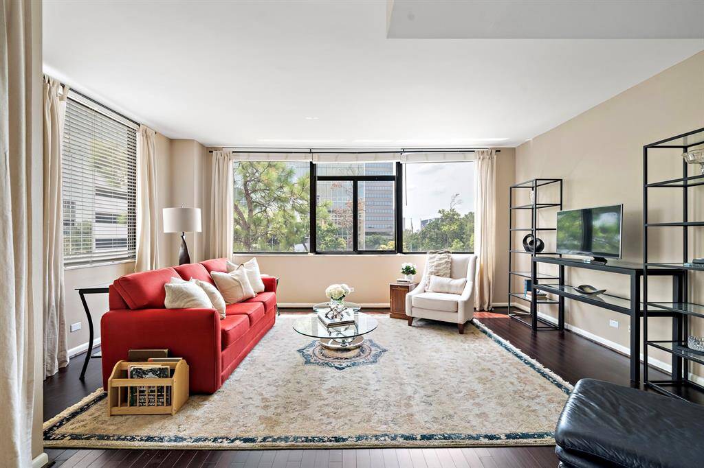 Located on the fifth floor, this 2,387 square foot corner unit boasts an open floor plan, three spacious bedrooms, a large dining and kitchen area, a laundry room, and updated bathrooms. Entertain guests in the living room featuring tall ceilings, timeless hardwood floors, and an abundance of windows.