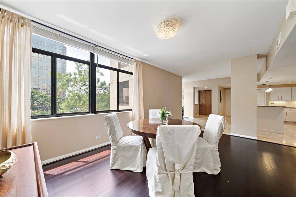 An ideal space to enjoy meals with tree-top neighborhood views! The expansive dining area offers gorgeous hardwood floors, seamless access to the kitchen, and ample space for large and intimate gatherings alike.