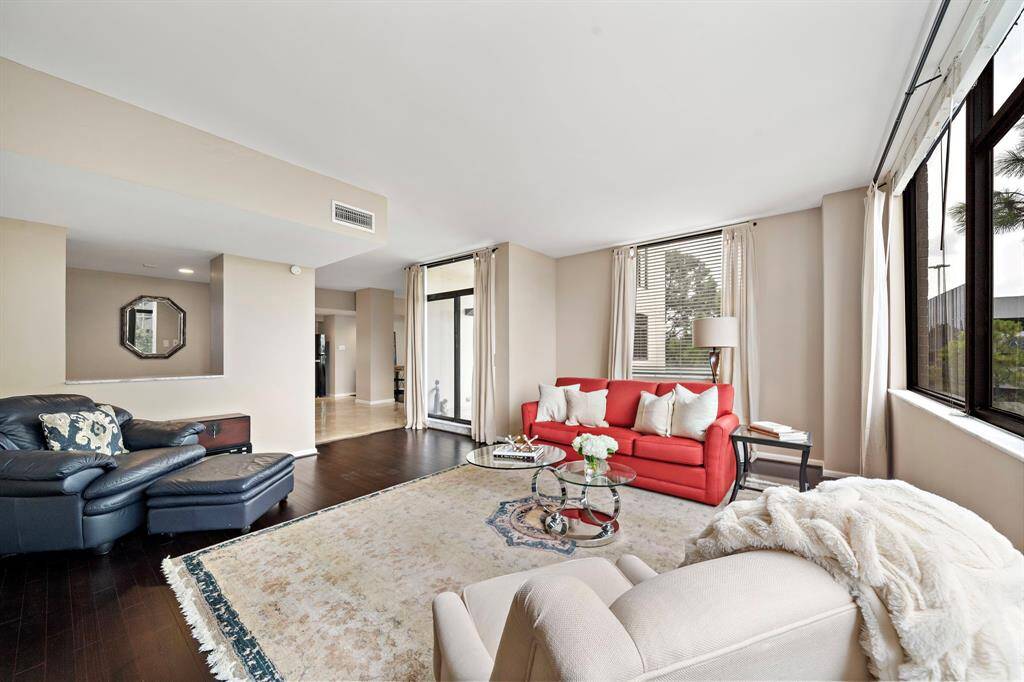 The expansive living area highlights generous accommodations for seating and direct access to the kitchen and formal dining area.