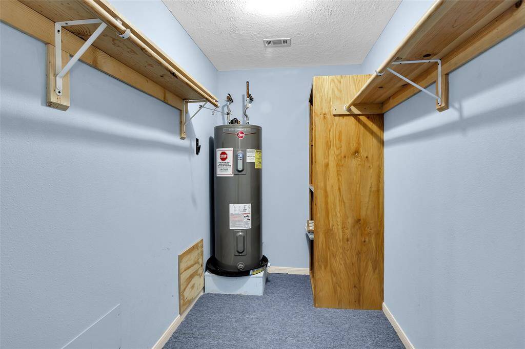 Spacious primary closet featuring ample shelving and storage solutions.