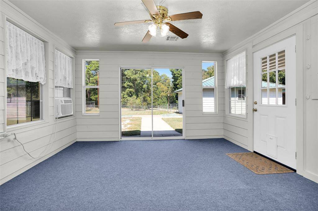Bright and versatile sunroom perfect for a hobby or utility space.