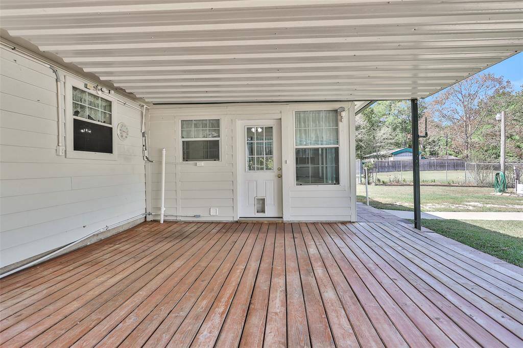 Enjoy the perfect outdoor retreat with this spacious covered deck, ideal for relaxing or entertaining in any weather.
