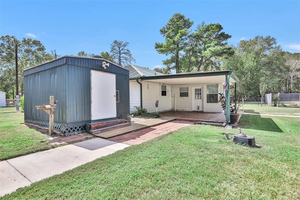 Experience serene outdoor living with a spacious covered porch and convenient pathways leading to the shed and garage.