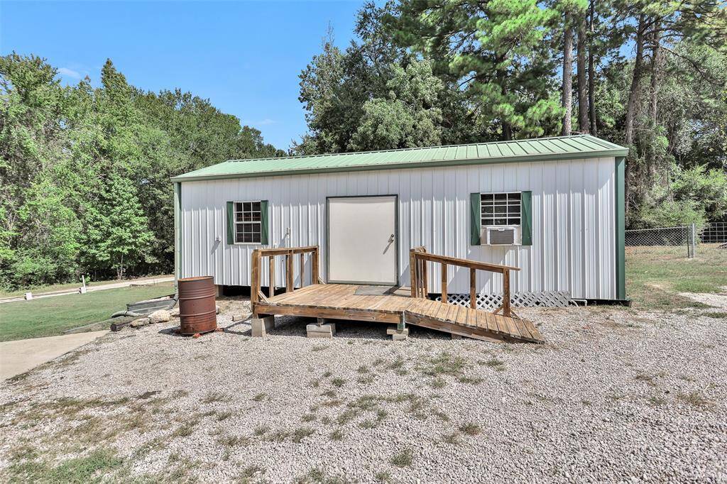 Charming guest house with a welcoming front entrance, nestled amid lush greenery for a perfect retreat.