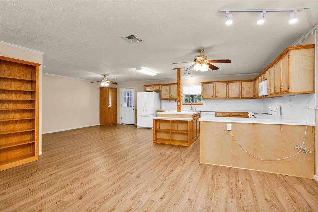 Ample space beside the island accommodates a large table for six, with plenty of room to move around comfortably.