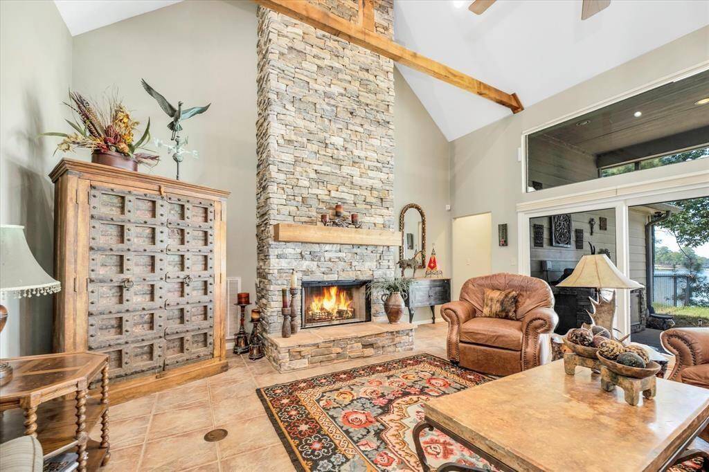 Gorgeous floor to ceiling stone fireplace in living room.