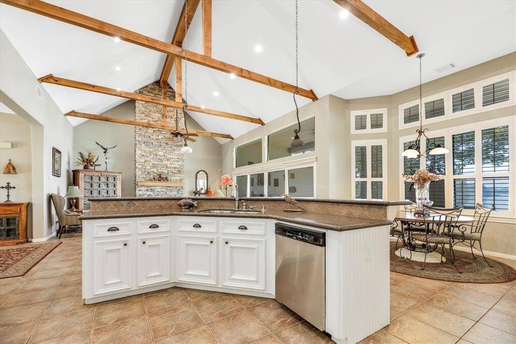 Angled kitchen island with eat in counter plus breakfast area allows family and guest plenty of options for enjoying breakfast.