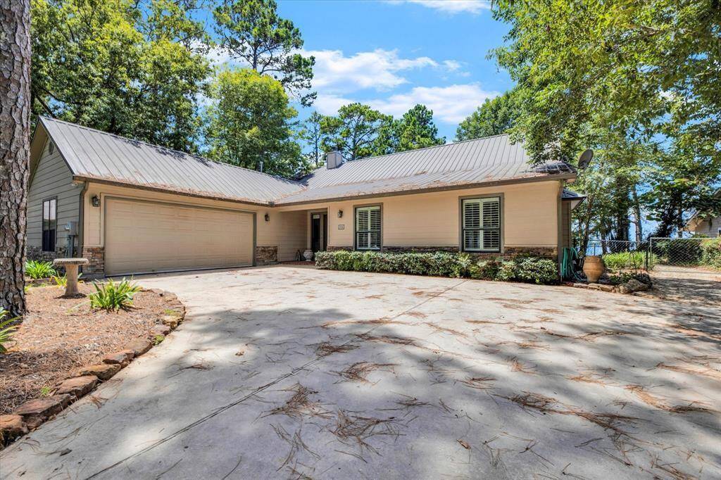 Concrete driveway leading up to the home and 2-car attached garage.