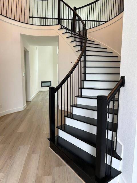 Spiral wood stairs greet you at the door.