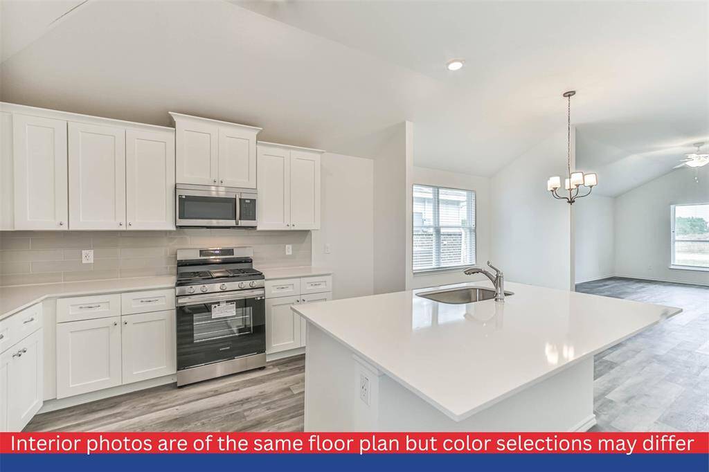 The spacious living room showcases a cozy atmosphere, with elegant hardwood flooring and large windows that fill the space with warmth and natural light.