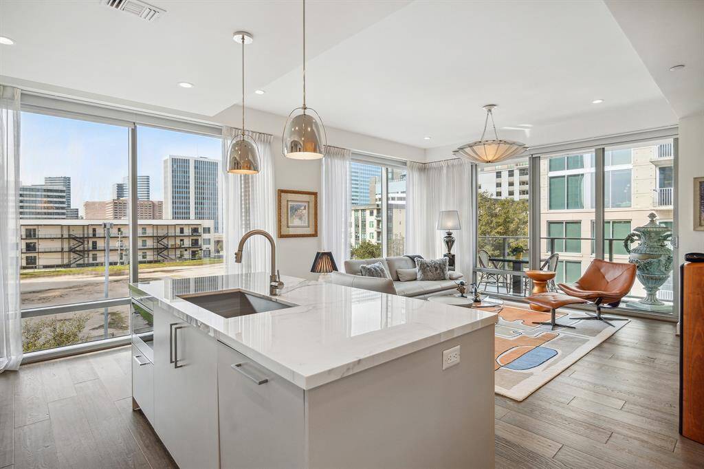Another view of the kitchen to living room with floor to ceiling views.