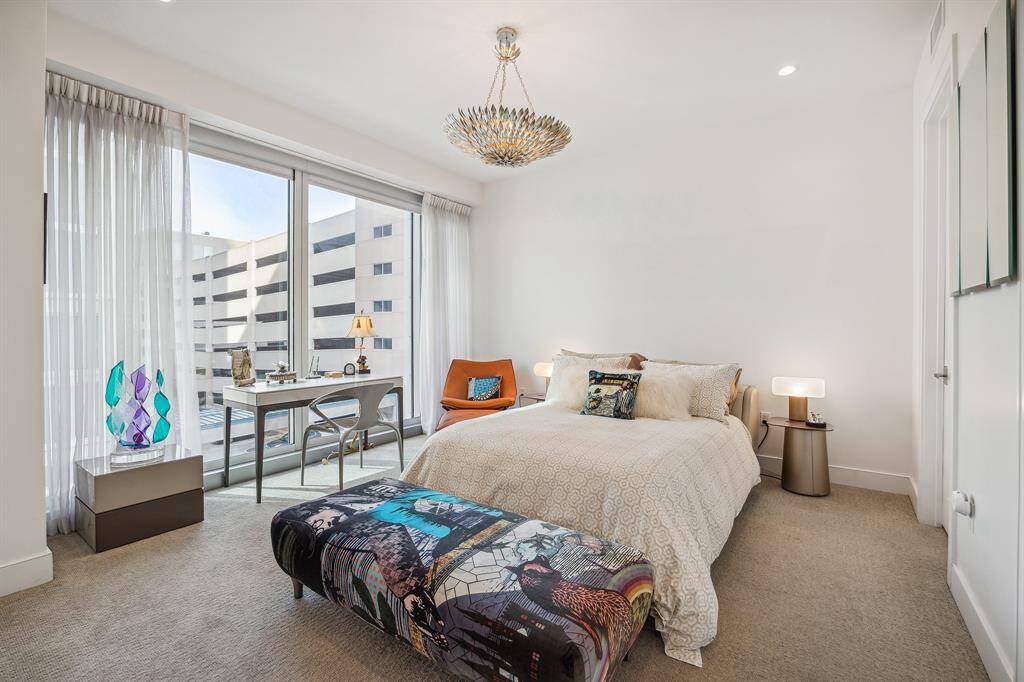 A relaxing primary suite with walk-in closet and en suite bath. Remote blackout shades with sheer drapes, neutral carpet. 10' ceilings throughout.