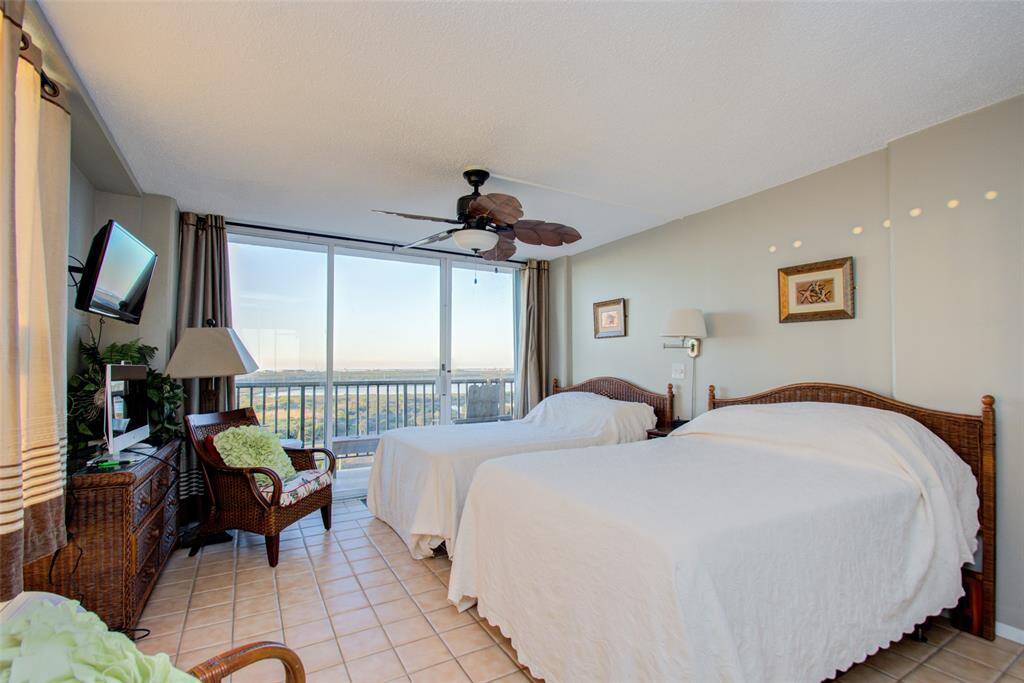 Second bedroom is like a spacious retreat, with tile flooring and a walk out balcony.