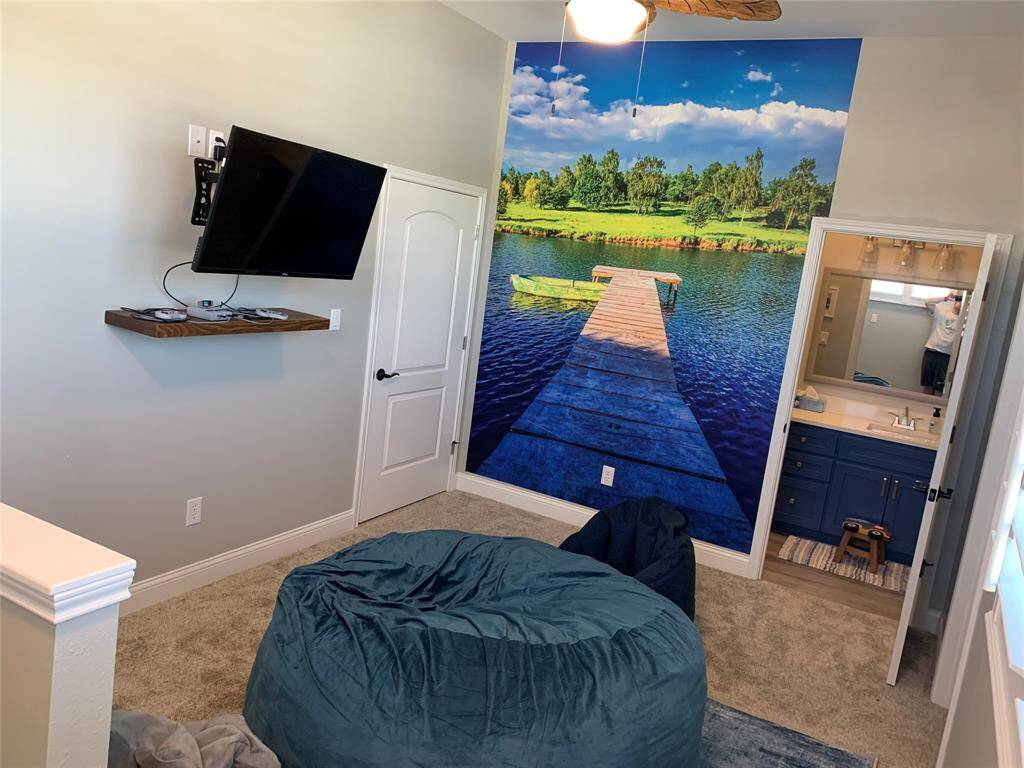 Loft area upstairs, door to attic space (attic is large enough to finish out for a 4th bedroom or game room if desired)