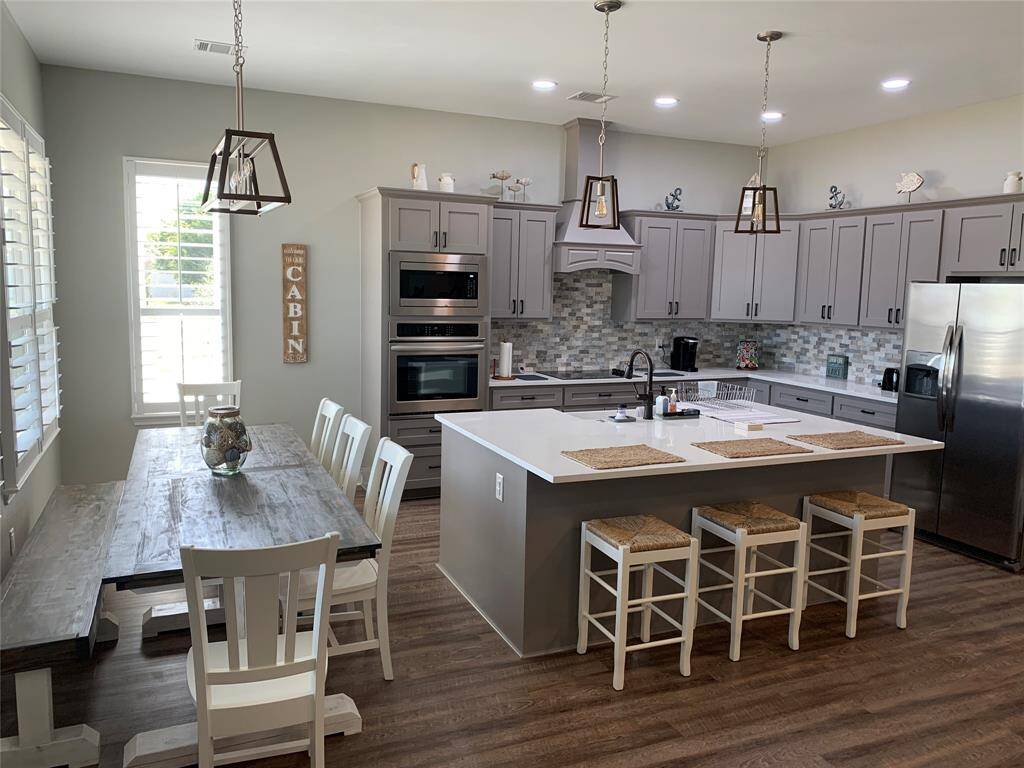 Kitchen includes quartzite countertops and large walk in pantry