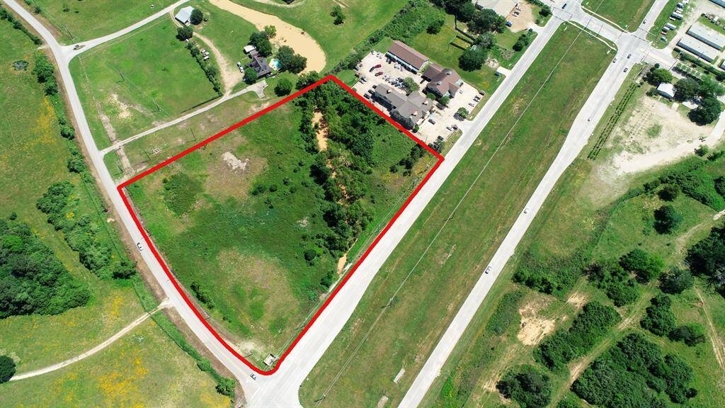 This aerial is looking northeast with FM 1093 in the foreground and Fulshear-Katy road on the left. You will notice the current drainage ditch that angles thru the property that is being relocated to the east property line.