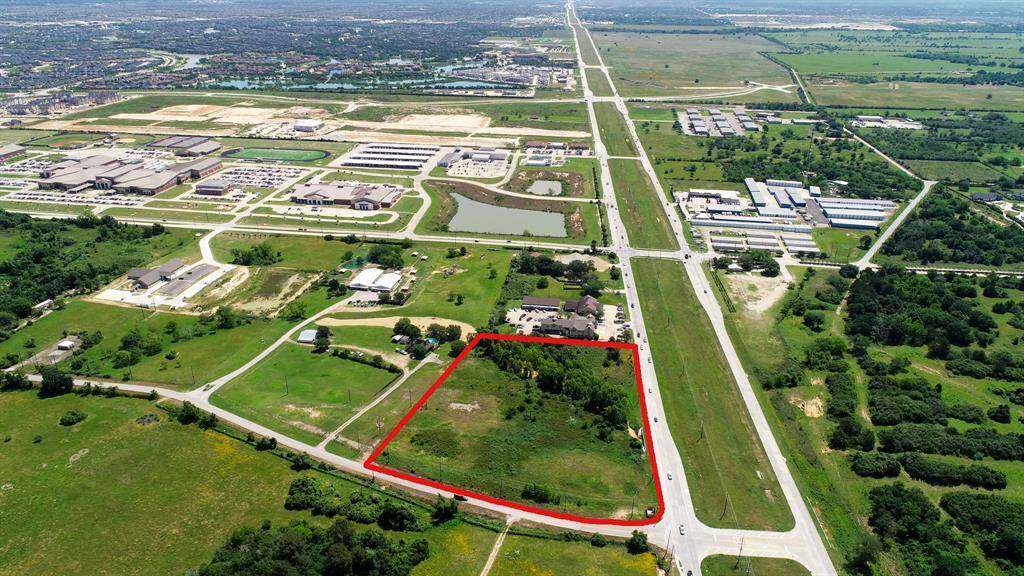 This view is looking East across the property and down FM 1093. The Fulshear High and Junior schools are next to the detention pond. Texas Heritage Parkway is just beyond.