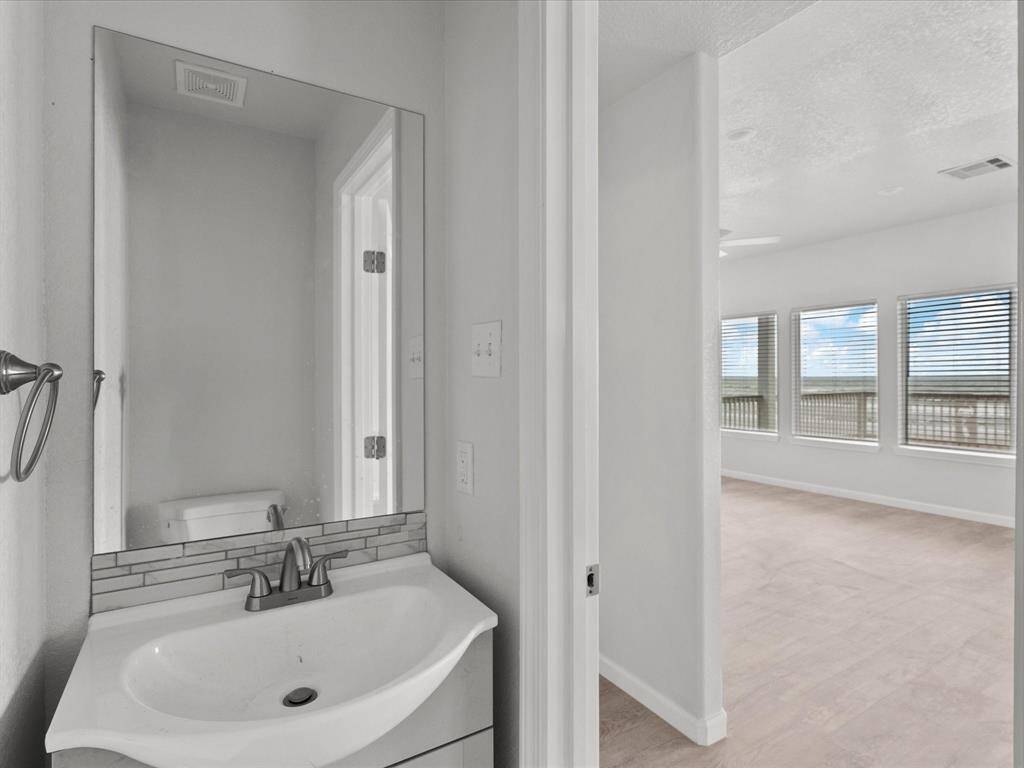 Convenient half bath with modern fixtures and easy access to living areas.