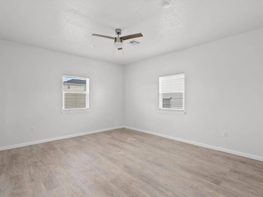 Spacious downstairs bedroom with ample natural light and modern finishes.
