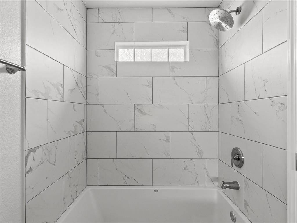 Elegant tiled shower with modern fixtures for a spa-like retreat.