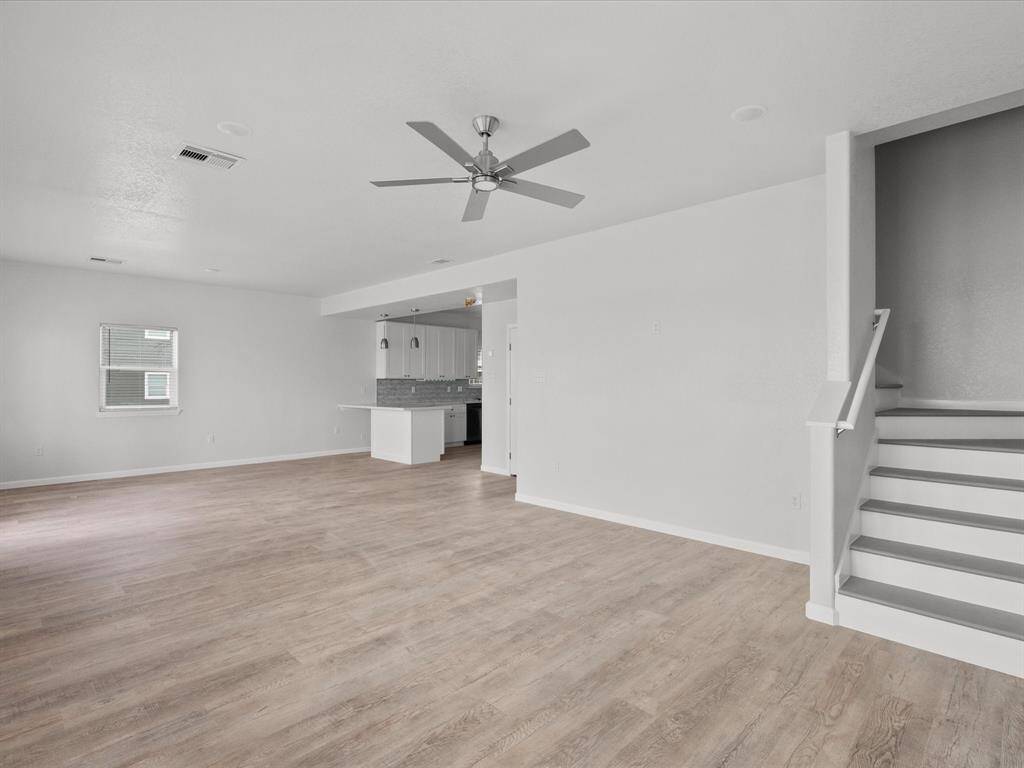 Conveniently located off the living area, the staircase offers easy access to the upper level.
