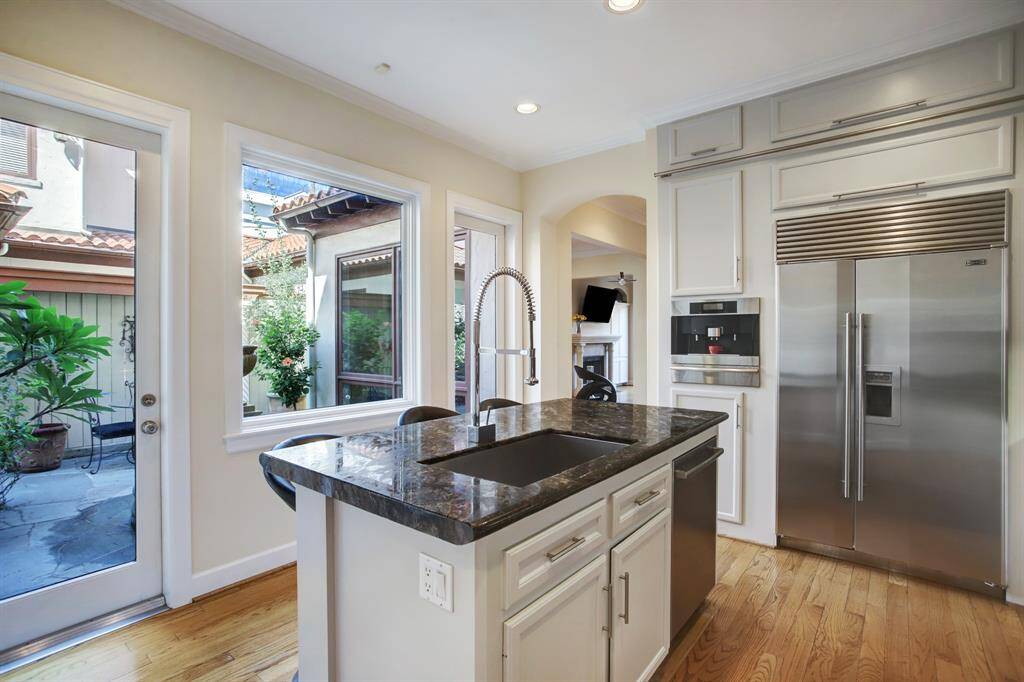 Notice that the oversized sink is equipped with a pot filler faucet with extendable spout and the Bosch dishwasher well situated at your fingertips!  There is never a shortage for refrigeration with the side by side Sub Zero.