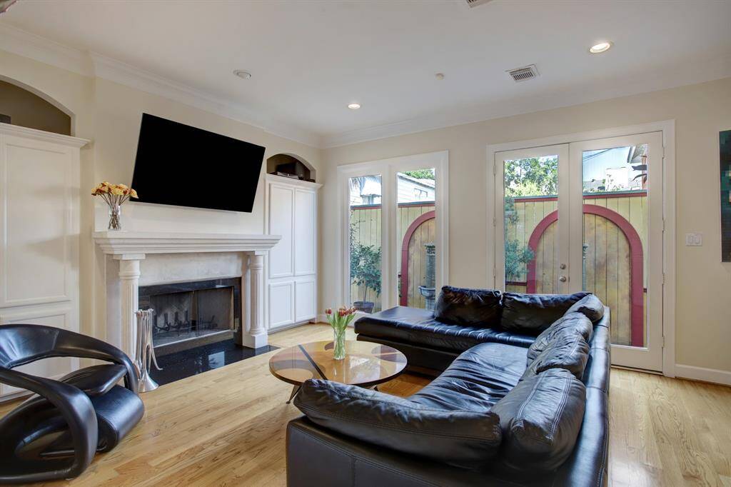 Notice the double French Doors which provide access to the outdoor lifestyle and bring plenty of light in.  There is an oversized fireplace with a gas log connection for Houston's chili days.