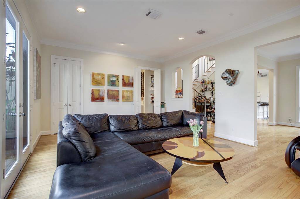From this view you can see the pantry style storage behind the doors on the left and the wine room where the doors are ajar in the photo.  Notice the walk around flow of the home making it the perfect floorplan for an open style flow!