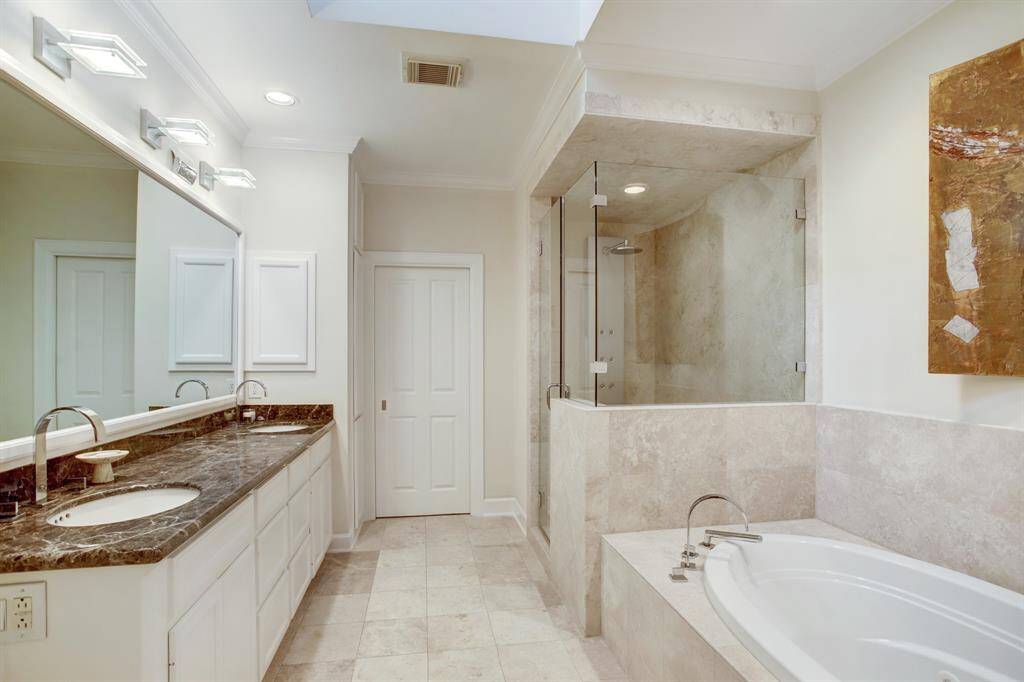 Nuetral colored stone and clean fresh white walls are inviting you to relax in the oversized jetted tub while you watch your favorite show on the TV which is installed BEHIND the mirror!  Be sure to ask for a demonstration during your showing!