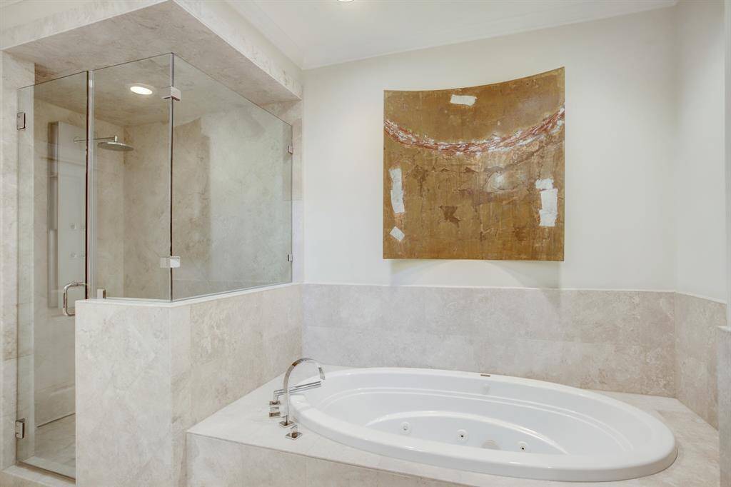 Here is a view of the Garden tub and stand alone body shower with glass enclosure with built-in bench.
