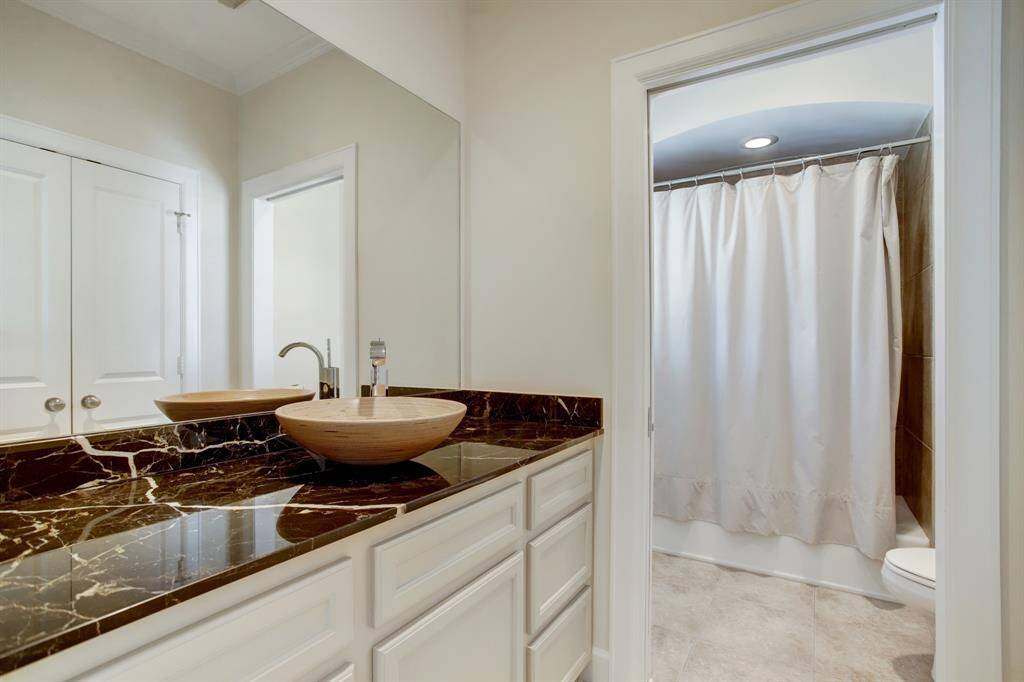 This ensuite bath also has a walk in closet across from the vanity.