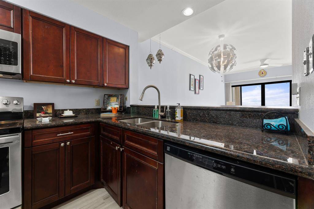 Another view of the kitchen with plenty of counterspace and storage - overlooking the living dining area and enjoy the gorgeous water view !!