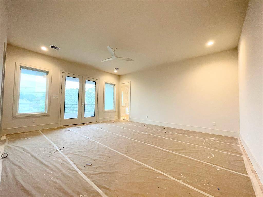 Primary Bedroom with double doors to private balcony. Photo Update 2/10/25